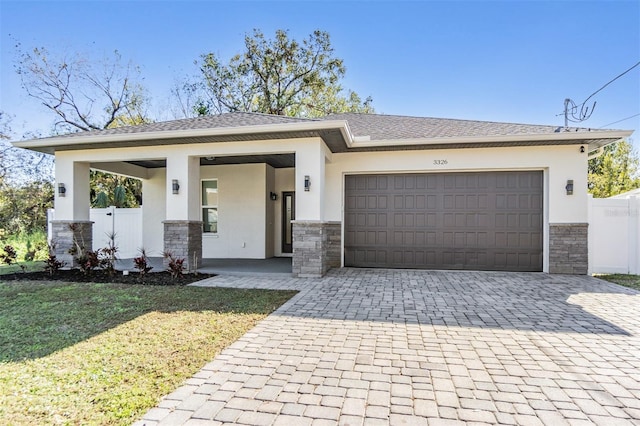 view of front of home with a front yard, a porch, and a garage