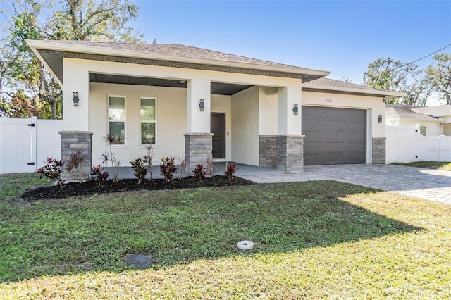 view of front facade featuring a front yard, a porch, and a garage