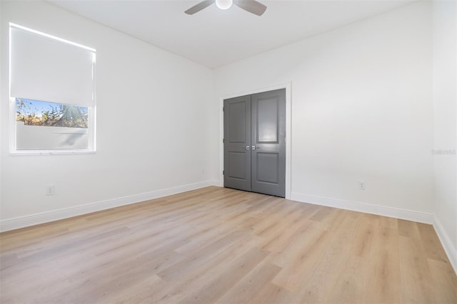 empty room with ceiling fan and light wood-type flooring