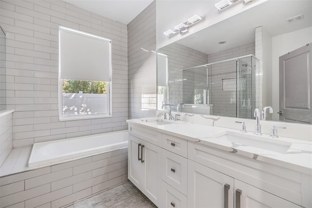 bathroom featuring vanity and separate shower and tub