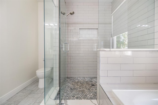 bathroom featuring separate shower and tub and toilet