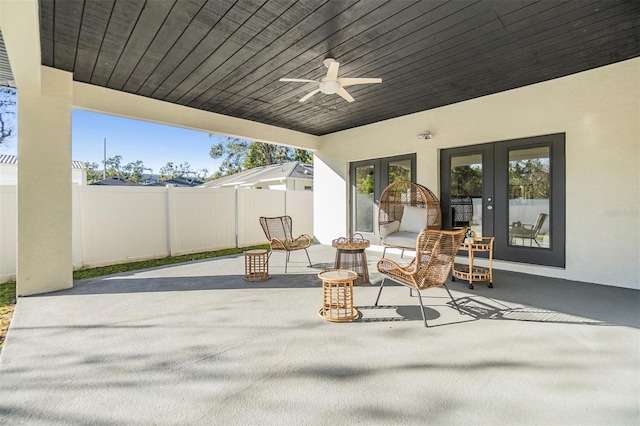 view of patio / terrace featuring ceiling fan and french doors