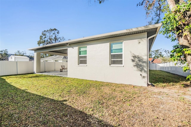 rear view of property with a patio and a lawn