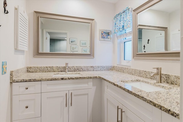 bathroom featuring a sink and double vanity