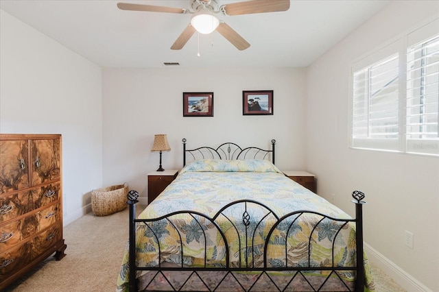 carpeted bedroom featuring visible vents, ceiling fan, and baseboards