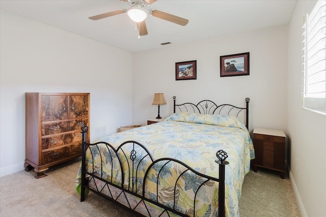 bedroom featuring light colored carpet, visible vents, ceiling fan, and baseboards