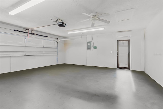 garage with a garage door opener and electric panel