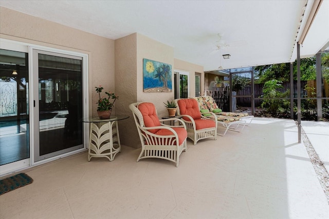 view of patio / terrace featuring ceiling fan and fence