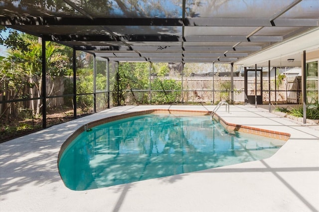 view of pool featuring a lanai, fence, a fenced in pool, and a patio