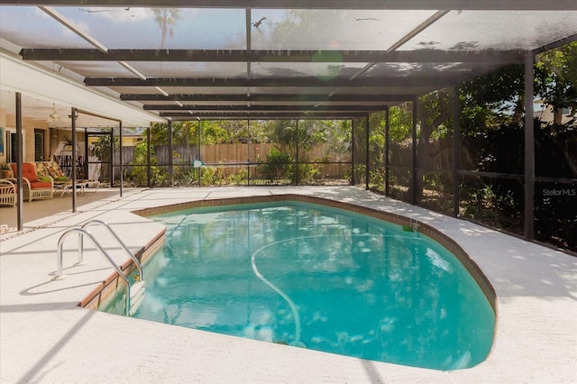 view of pool featuring a patio, a fenced backyard, glass enclosure, and a fenced in pool