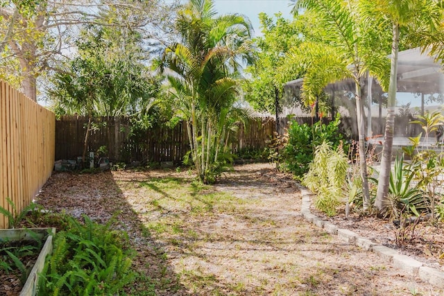 view of yard featuring a lanai and a fenced backyard