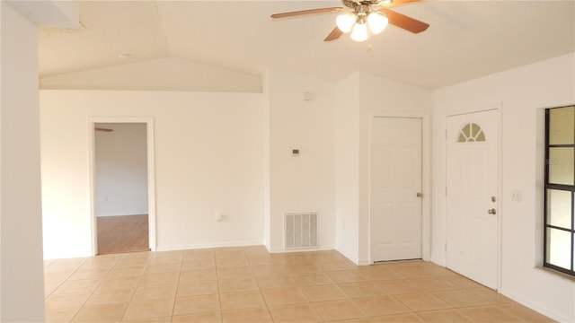 tiled spare room with ceiling fan and lofted ceiling