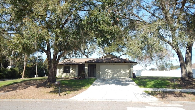 single story home with a garage and a front yard