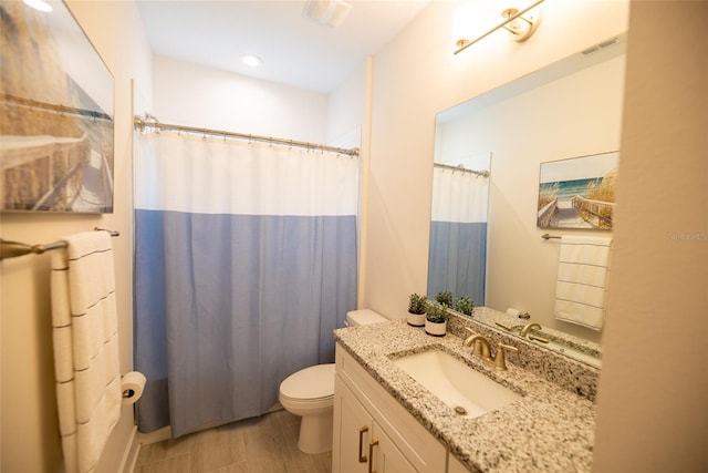 full bath featuring toilet, vanity, and visible vents