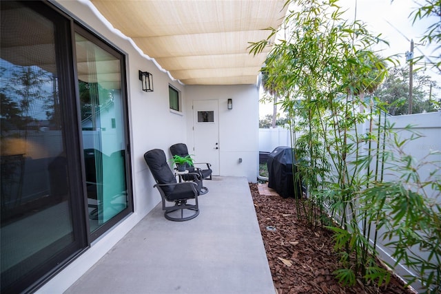 view of patio with fence and area for grilling