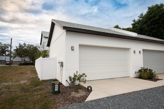 view of property exterior featuring a garage and stucco siding