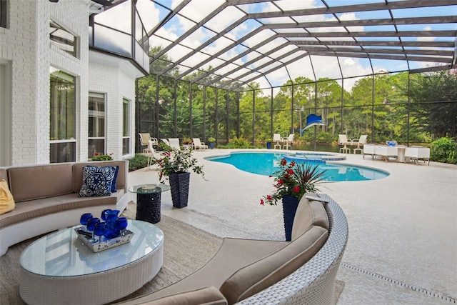 view of pool with a lanai, an outdoor living space, and a patio area