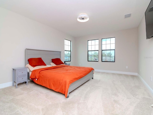 bedroom featuring light colored carpet