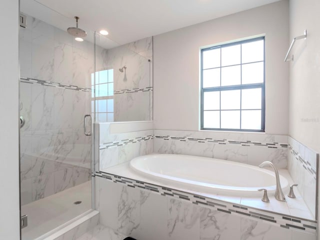 bathroom featuring separate shower and tub and plenty of natural light