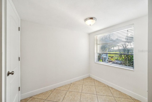 unfurnished room featuring light tile patterned floors