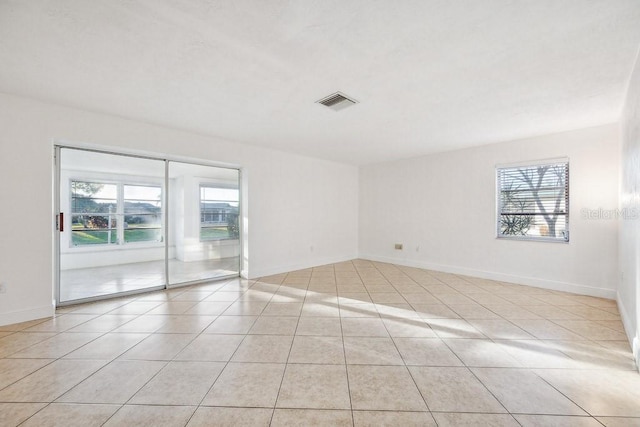 unfurnished room featuring plenty of natural light and light tile patterned flooring