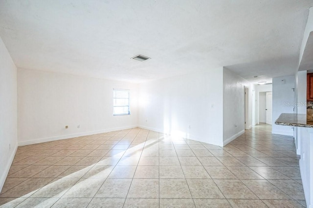 empty room with light tile patterned floors