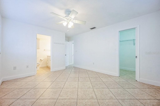 empty room featuring ceiling fan and light tile patterned floors