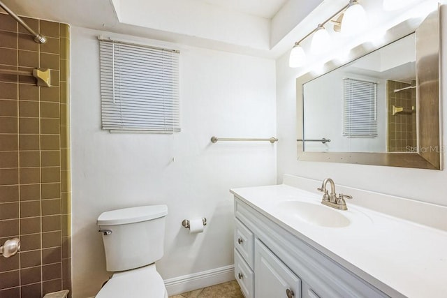 bathroom featuring tile patterned flooring, vanity, toilet, and a tile shower