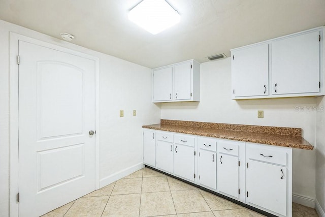 kitchen featuring white cabinets and light tile patterned floors