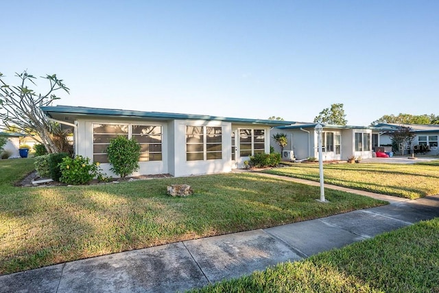 ranch-style house featuring a front lawn