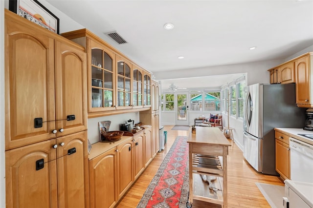 kitchen with stainless steel fridge, white dishwasher, light hardwood / wood-style flooring, and ceiling fan