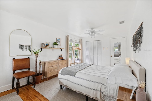 bedroom with ceiling fan, wood-type flooring, and a closet