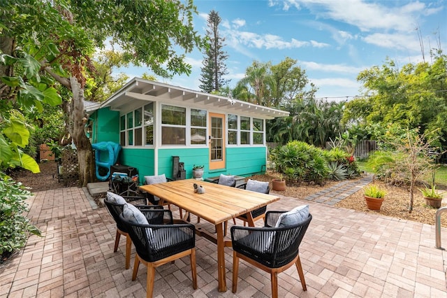 view of patio / terrace featuring a sunroom