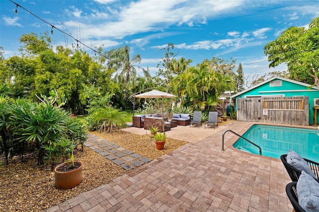 view of pool with outdoor lounge area and a patio