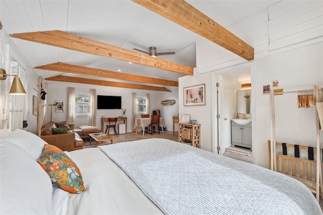 bedroom with vaulted ceiling with beams, sink, and connected bathroom