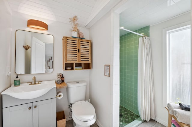 bathroom featuring vanity, toilet, and curtained shower