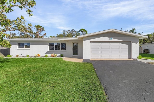 ranch-style home featuring a front yard and a garage