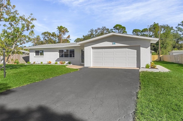 single story home with a garage and a front lawn