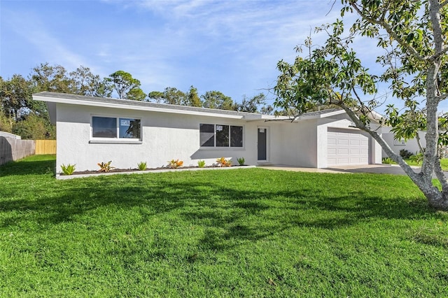 ranch-style home featuring a garage and a front lawn