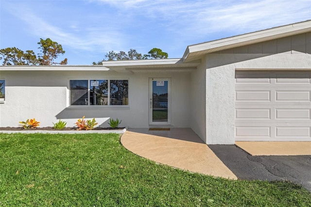 entrance to property with a yard and a garage