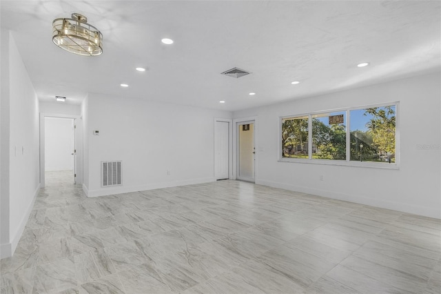 spare room featuring a notable chandelier