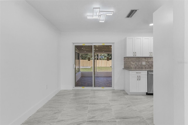 kitchen with dishwasher, tasteful backsplash, and white cabinetry