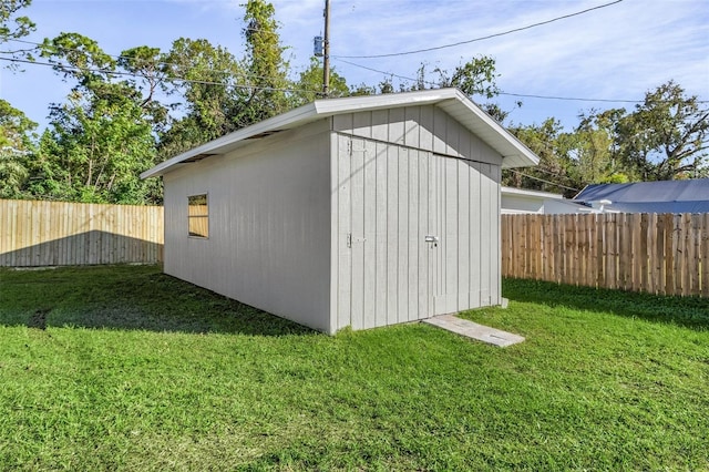 view of outbuilding featuring a yard