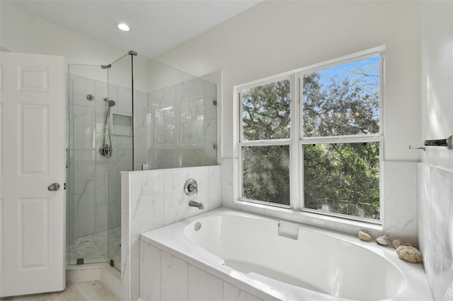 bathroom with shower with separate bathtub