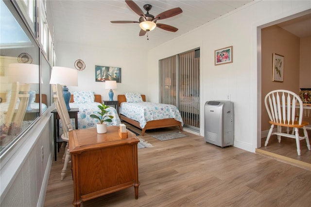 bedroom featuring light wood-style flooring and baseboards