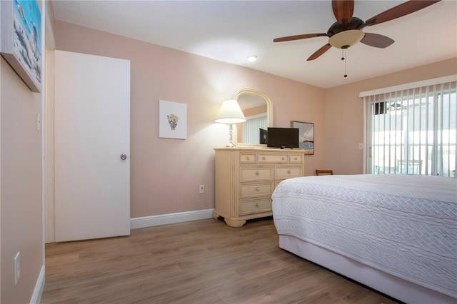 bedroom with access to exterior, baseboards, ceiling fan, and light wood finished floors