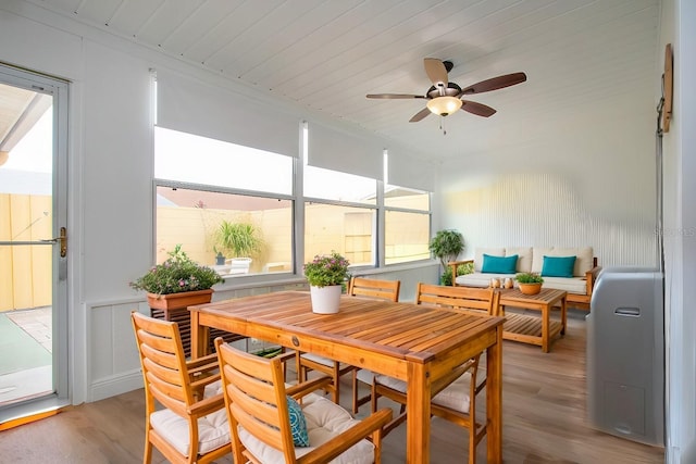 sunroom with wood ceiling, plenty of natural light, and a ceiling fan