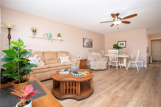 living area with ceiling fan and light wood finished floors