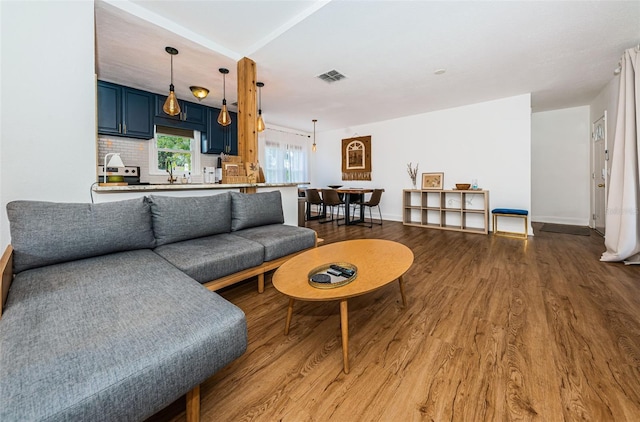 living room with hardwood / wood-style flooring and sink