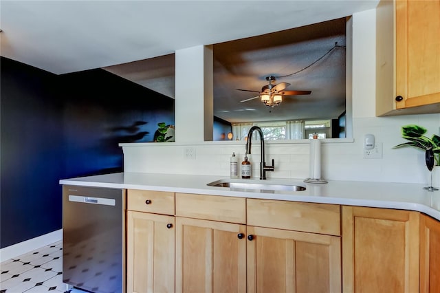 kitchen with light brown cabinets, sink, stainless steel dishwasher, ceiling fan, and tasteful backsplash